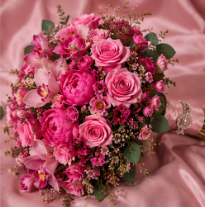 Pink peony and rose bouquet on pink satin