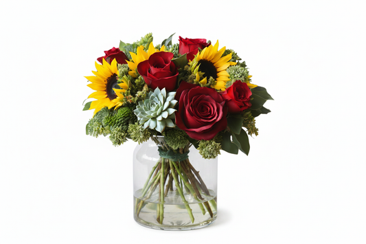 Bold & Beautiful floral arrangement with sunflowers, red roses, green poms and a succulent in a clear glass vase by Colour Me Floral Shoppe